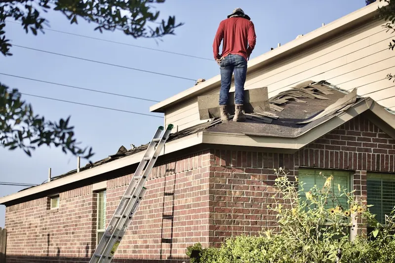 Professional roofer working on a residential roof in New Holland